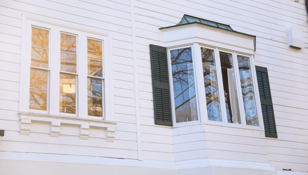 Bay and Bow Windows in a beautiful house, highlighting the importance of hiring a trustworthy door and window installation company that provides quality service.