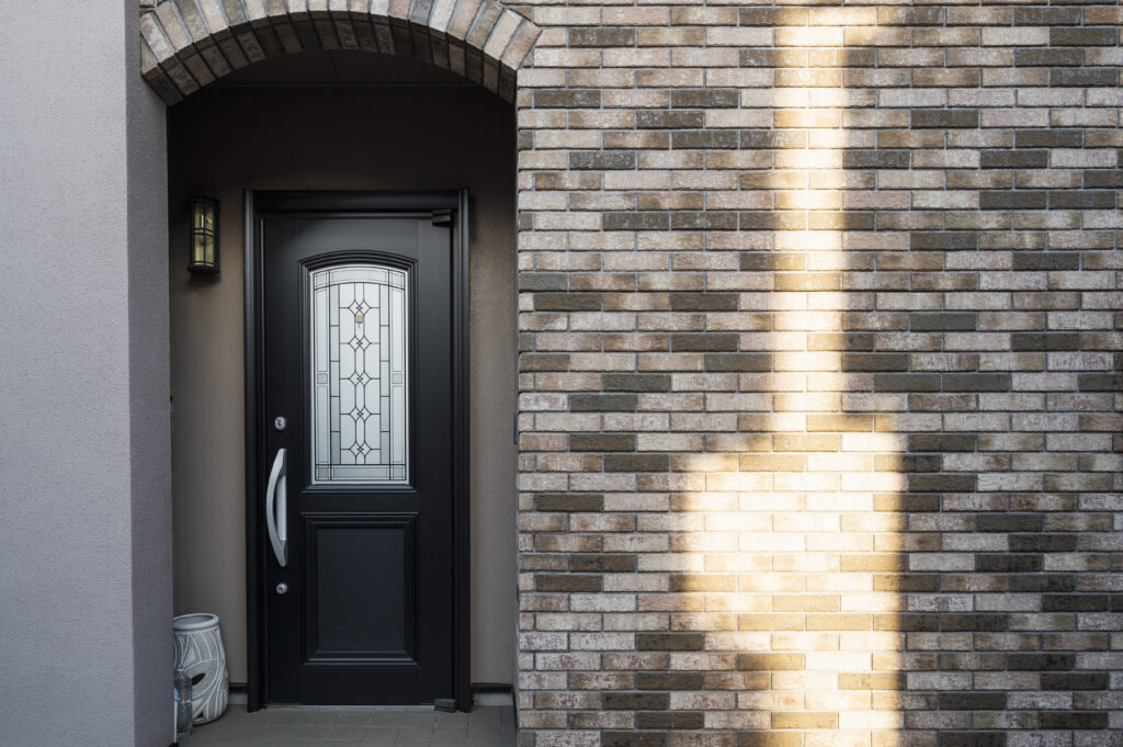 Dark wooden front door, representing the importance of having doors and windows installed by a trusted company.