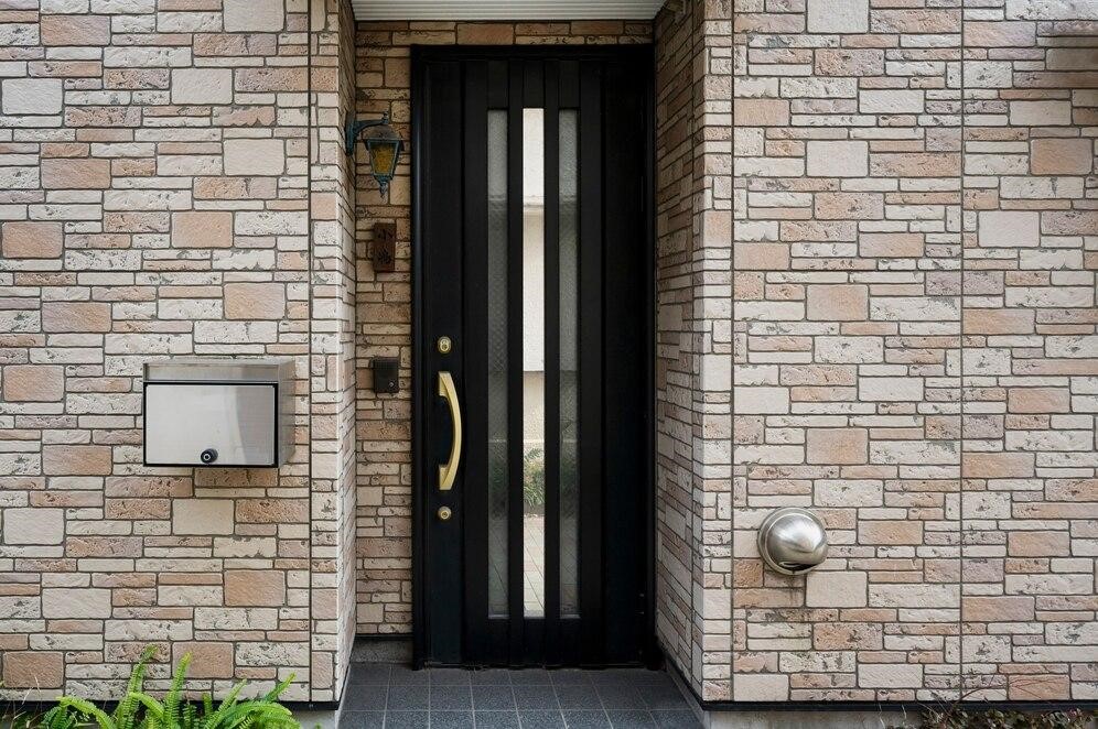 Black iron entry door in a building with a modern design.