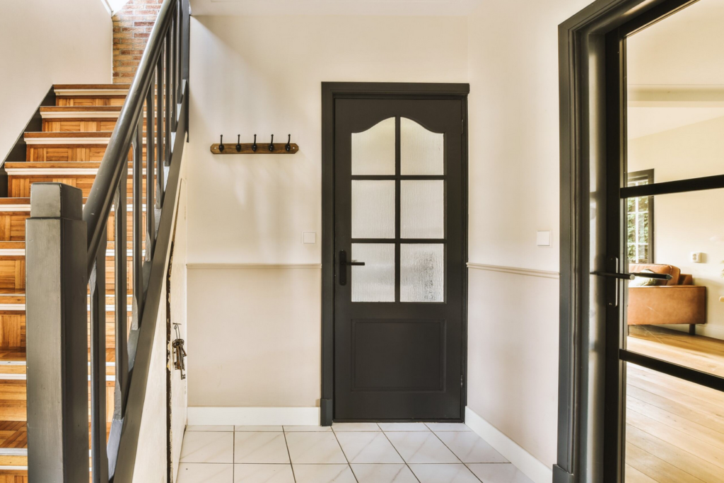 Interior of a building, showing the black fiberglass entry door.