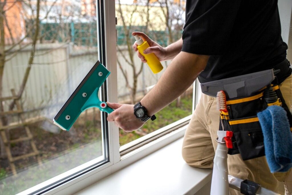 Man cleaning a window installation mess