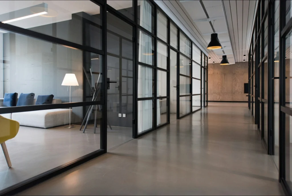 Modern building with floor-to-ceiling doors, representing the importance of following commercial window and door trends in 2025.